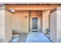 Front entrance with a dark wood door and covered entryway at 4027 E Pueblo Ave, Mesa, AZ 85206