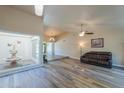 Spacious living room with wood-look floors and a leather couch at 4027 E Pueblo Ave, Mesa, AZ 85206