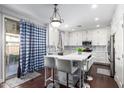 Spacious kitchen with white cabinets, island, and modern appliances at 4332 E Vallejo Ct, Gilbert, AZ 85298