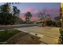 View of a quiet residential street at dusk with houses and trees at 4332 E Vallejo Ct, Gilbert, AZ 85298