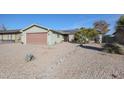 Charming ranch home with a well-maintained front yard and attached garage at 4938 W Michelle Dr, Glendale, AZ 85308