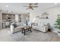 Comfortable living room with adjacent kitchen and a view of the stairs at 518 E Balao Dr, Phoenix, AZ 85085