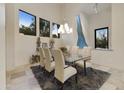 Elegant dining room with glass table and chandelier at 5301 E Calle Del Norte --, Phoenix, AZ 85018