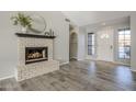 Living room featuring a brick fireplace and wood-look tile floors at 5821 W Kesler St, Chandler, AZ 85226