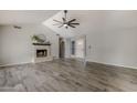 Living room with fireplace and view into kitchen and dining area at 5821 W Kesler St, Chandler, AZ 85226