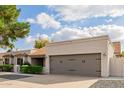 House exterior showcasing a two-car garage and neatly kept landscaping at 6131 E Kings Ave, Scottsdale, AZ 85254