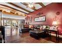 Open living area with leather sectional sofa, hardwood floors, and red walls at 723 S Edgewater Dr, Mesa, AZ 85208