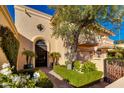 Elegant entryway with a dark wood door and manicured landscaping at 7500 E Mccormick Pkwy # 78, Scottsdale, AZ 85258