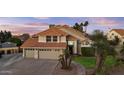 Charming two-story home featuring a three-car garage, red tile roof, and mature landscaping at 7804 W Pershing Ave, Peoria, AZ 85381