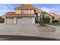 Charming two-story home featuring a three-car garage, red tile roof, and mature landscaping at 7804 W Pershing Ave, Peoria, AZ 85381