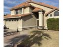 Two story home with terracotta tile roof, light stucco and walkway to the front door at 7804 W Pershing Ave, Peoria, AZ 85381