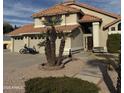 Well-maintained two-story home with a terracotta tile roof, a three-car garage, and desert landscaping at 7804 W Pershing Ave, Peoria, AZ 85381