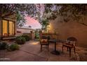 Relaxing outdoor courtyard space with wrought iron furniture, lush plants, and a peaceful ambiance at 7878 E Gainey Ranch Rd # 41, Scottsdale, AZ 85258