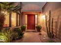 Inviting front entrance with a red door, decorative plants, and stylish lighting at 7878 E Gainey Ranch Rd # 41, Scottsdale, AZ 85258