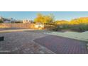 Brick patio area in backyard with desert landscape beyond at 831 N Arroya Rd, Apache Junction, AZ 85119