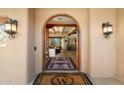 Elegant entryway with arched doorway, stone flooring, and warm lighting at 8375 E Via Dona Rd, Scottsdale, AZ 85266