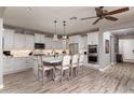 Bright kitchen with island, double oven, and white cabinets at 10317 E Tillman Ave, Mesa, AZ 85212