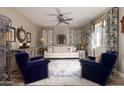 Cozy living room featuring a beige sofa and blue armchairs at 10317 E Tillman Ave, Mesa, AZ 85212