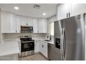 Updated kitchen with white shaker cabinets and stainless steel appliances at 11411 E Crescent Ave, Mesa, AZ 85208