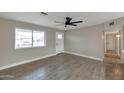 Bright and airy living room with wood-look tile flooring at 11411 E Crescent Ave, Mesa, AZ 85208