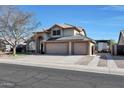 Two-story house with three-car garage and solar panels at 11553 N 76Th Dr, Peoria, AZ 85345