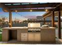 Outdoor kitchen with a built-in grill and ample counter space at 1157 E Liberty Ln, Gilbert, AZ 85296