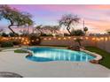 Relaxing pool area with a waterfall, string lights, and plenty of space for entertaining at 1157 E Liberty Ln, Gilbert, AZ 85296