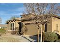 Charming home exterior featuring a well-maintained lawn and a two-car garage, creating curb appeal at 12075 E Chevelon Trl, Gold Canyon, AZ 85118