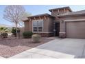 One-story home with a two-car garage and desert landscaping at 12075 E Chevelon Trl, Gold Canyon, AZ 85118