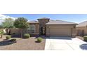 House with a tile roof, two-car garage, and front yard landscaping at 12075 E Chevelon Trl, Gold Canyon, AZ 85118