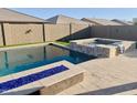 Beautiful backyard pool and spa with a modern blue fire feature, perfect for entertaining and relaxation at 12075 E Chevelon Trl, Gold Canyon, AZ 85118