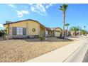 Front view of a single-story house with a landscaped yard at 12323 W Tigerseye Dr, Sun City West, AZ 85375