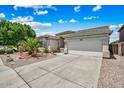 House with a driveway, landscaping, and a two-car garage at 12930 W Pershing St, El Mirage, AZ 85335