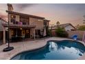 Stunning kidney-shaped pool with patio and two-story home at 1540 W Orchid Ln, Chandler, AZ 85224