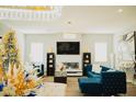 Elegant living room with sectional sofa, fireplace, and large TV at 15541 S 181St Ln, Goodyear, AZ 85338