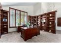 Bright home office with ample built-in shelving and a large desk at 16614 N 51St St, Scottsdale, AZ 85254