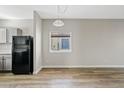 Simple dining area with wood-look flooring and a window with blinds at 1866 E Dust Devil Dr, San Tan Valley, AZ 85143