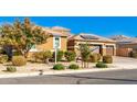 Home exterior showcasing a well-maintained front yard and garage at 18904 W Mercer Ln, Surprise, AZ 85388