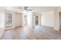 Bright living room with wood-look floors and sliding glass door to balcony at 200 E Southern Ave # 175, Tempe, AZ 85282