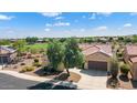 Single-story home with solar panels, a two-car garage, and desert landscaping at 20515 N 264Th Ave, Buckeye, AZ 85396