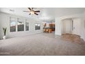 Spacious living room with tile and carpet flooring, and views into the kitchen at 2441 W Beverly Rd, Phoenix, AZ 85041