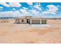 An inviting single-story home with a neutral color scheme and a spacious three-car garage at 25519 W Brookhart Way, Wittmann, AZ 85361