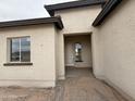 Close up of a stucco single story home, showing the front door at 25519 W Brookhart Way, Wittmann, AZ 85361