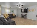 Living room features a gray sectional sofa, fireplace, and large TV at 2602 W Roeser Rd, Phoenix, AZ 85041