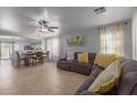 Spacious living room with tile floors, gray sectional sofa, and a ceiling fan at 2602 W Roeser Rd, Phoenix, AZ 85041