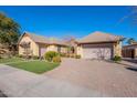 Beautiful home with a two-car garage and nicely landscaped front yard at 2952 E Warbler Rd, Gilbert, AZ 85297