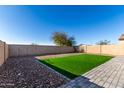 Landscaped backyard with artificial turf and a block wall at 30358 N Juniper Dr, Florence, AZ 85132