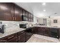 Modern kitchen featuring dark wood cabinets and granite countertops at 30358 N Juniper Dr, Florence, AZ 85132