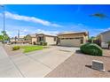 Charming single-story home with desert landscaping, a two-car garage, and a cozy curb appeal at 3383 E Santa Fe Ln, Gilbert, AZ 85297