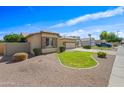 Well-kept single-story home with a grassy front yard and desert landscaping accents at 3383 E Santa Fe Ln, Gilbert, AZ 85297
